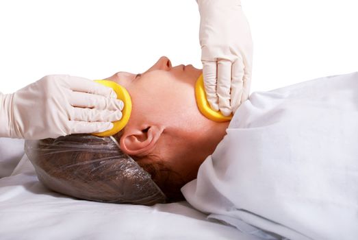 Beautiful woman in spa salon on the cleaning procedure of the face.