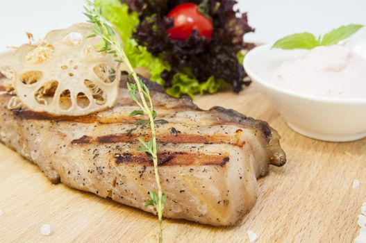 Catfish steak cooking on a grill in the restaurant