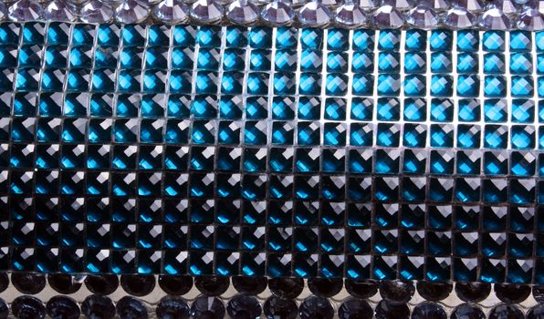 A background with a beautiful pattern of shiny blue studs.