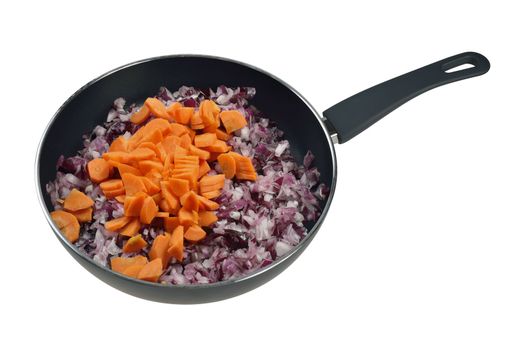 Onions and carrots in a frying pan. Isolated on white.