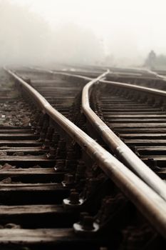Railway in fog on station, outdoor landscape