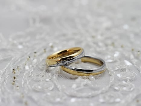 Wedding rings, pearls and tulle fabric