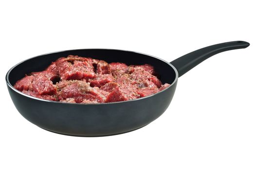 Raw meat in a frying pan. Isolated on white.