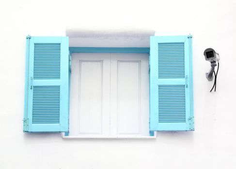 blue Greek Style windows with cctv on wall