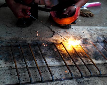 worker welding connecting square bar  without gloves