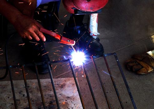 worker welding connecting square bar  without gloves