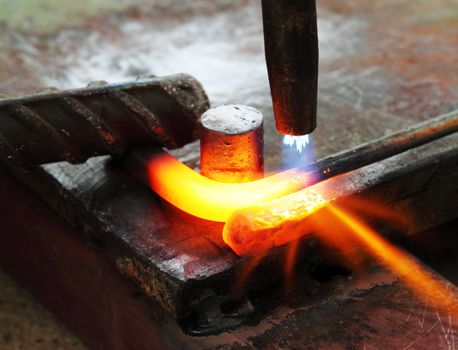 Gas heating cutting metal using torch and bending square bar