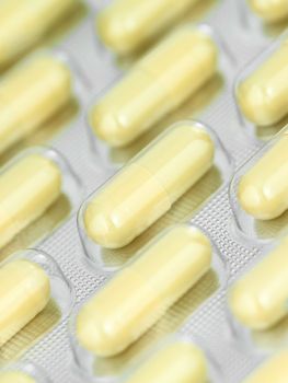 pack of yellow pills, close-up