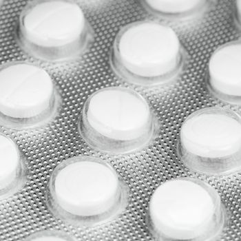 pack of white pills, close-up