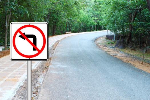 don't turn left sign with a right curved road