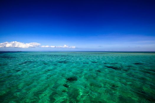 Beautiful Fiji atoll island with white beach in the middle of the ocean.