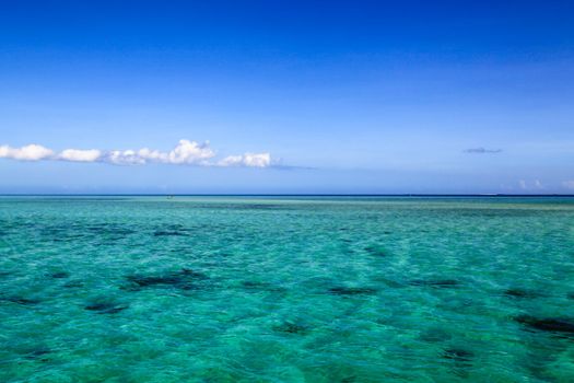 Beautiful Fiji atoll island with white beach in the middle of the ocean.