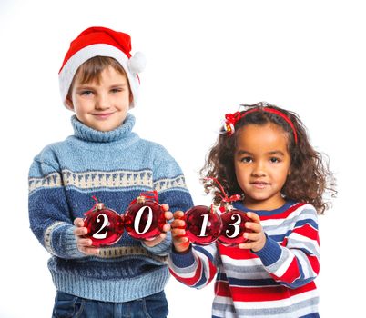 Christmas theme - Kids in Santa's hat holding a christmas ball with 2013 against a white background. Focus on the ball
