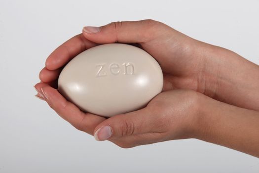 Hand holding soap inscribed ZEN