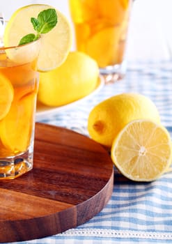 Close up of fresh and cold ice tea with sliced lemon and mint