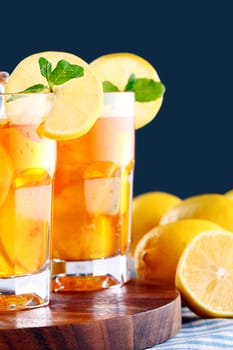 Close up of fresh and cold ice tea with sliced lemon and mint