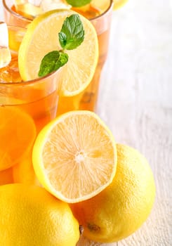 Fresh and cold ice tea with sliced lemon and mint