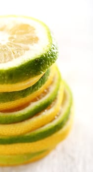 Macro shoot of sliced lemon and lime on a white surface