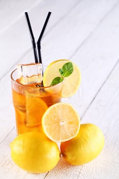 Fresh and cold ice tea with sliced lemon and mint