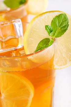 Fresh and cold ice tea with sliced lemon and mint