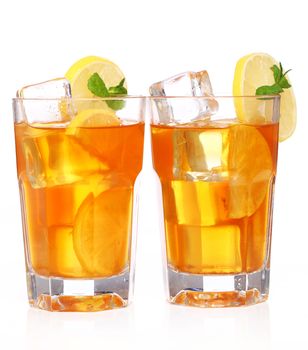 Fresh and cold ice tea with sliced lemon and mint