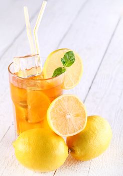 Fresh and cold ice tea with sliced lemon and mint