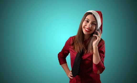 smiling business christmas girl at the phone on blue background