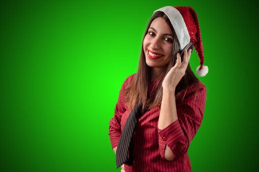 smiling business christmas girl at the phone on green background