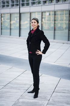 smiling business girl in front of modern building