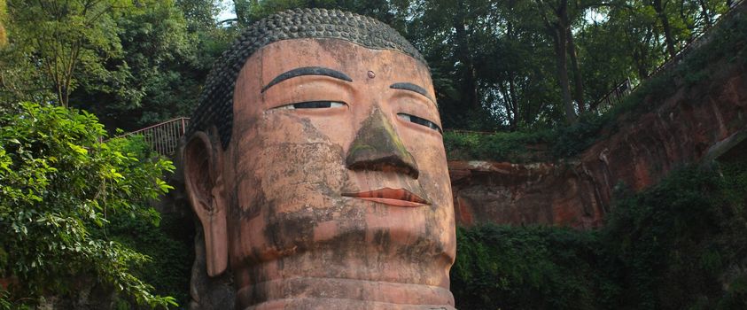 Head of Leshan Giant Buddha. It is the largest stone Buddha in the world and it is by far the tallest pre-modern statue in the world. Leshan Giant Buddha Scenic Area has been listed as a UNESCO World Heritage Site since 1996.
