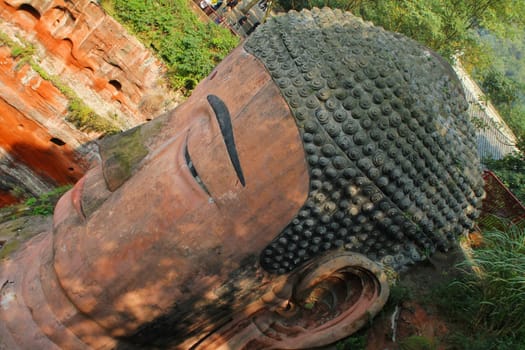 Head of Leshan Giant Buddha. It is the largest stone Buddha in the world and it is by far the tallest pre-modern statue in the world. Leshan Giant Buddha Scenic Area has been listed as a UNESCO World Heritage Site since 1996.