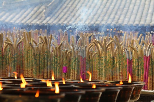 Incense and candles burning in a Buddhist temple in China
