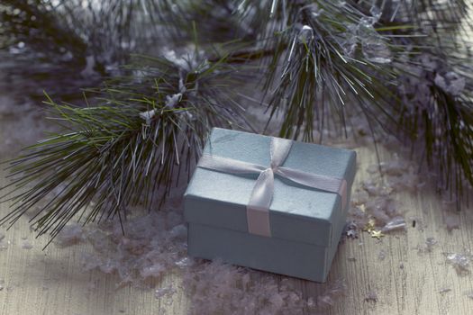 Gift box stands near the snow-covered trees