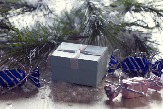 Gift box stands near the snow-covered trees