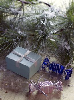 Gift box stands near the snow-covered trees