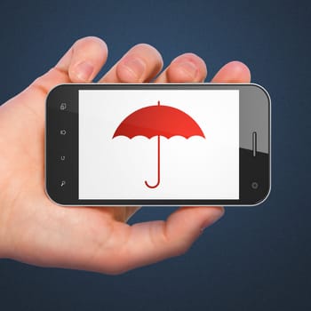 Hand holding smartphone with Umbrella on display. Generic mobile smart phone in hand on dark blue background.