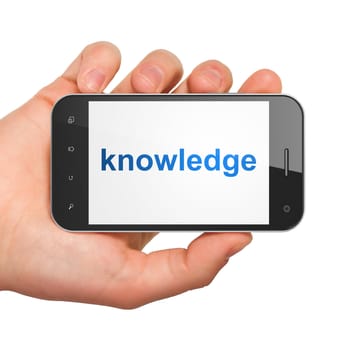 Hand holding smartphone with word knowledge on display. Generic mobile smart phone in hand on white background.