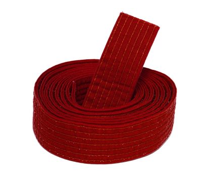 Coiled karate red belt isolated on white background