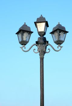 old street light against a blue sky