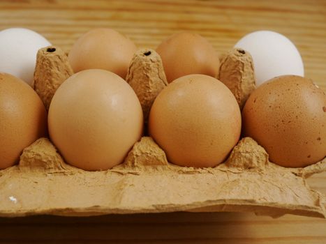 brown eggs on a wooden surface indoor