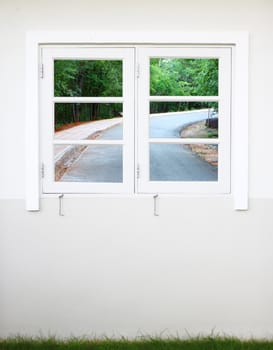 white wooden window with right curve road view