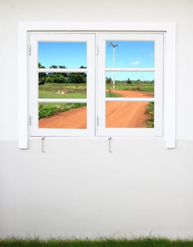 white wooden window with soil curve road view