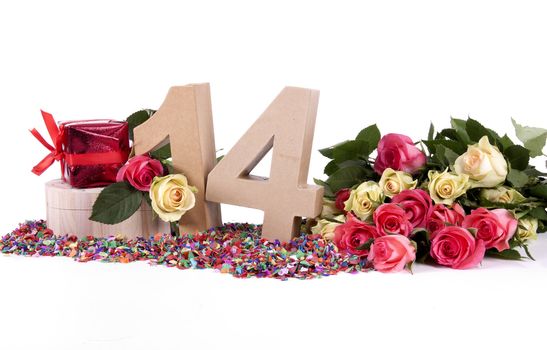 Number of age in a colorful studio setting with fresh roses on a bottom of confetti