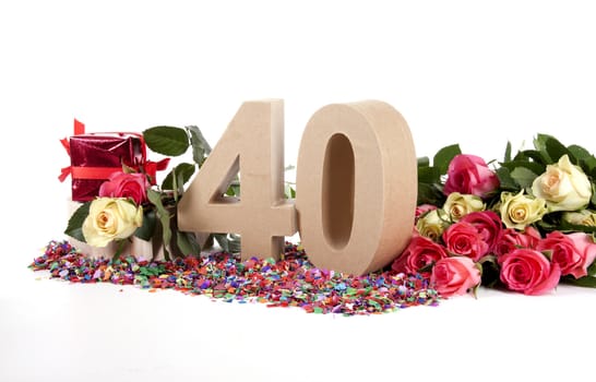 Number of age in a colorful studio setting with fresh roses on a bottom of confetti