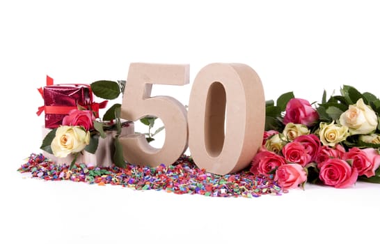 Number of age in a colorful studio setting with fresh roses on a bottom of confetti