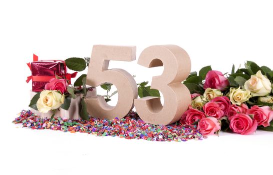 Number of age in a colorful studio setting with fresh roses on a bottom of confetti