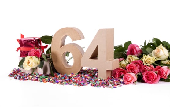 Number of age in a colorful studio setting with fresh roses on a bottom of confetti