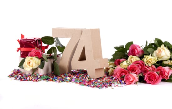 Number of age in a colorful studio setting with fresh roses on a bottom of confetti