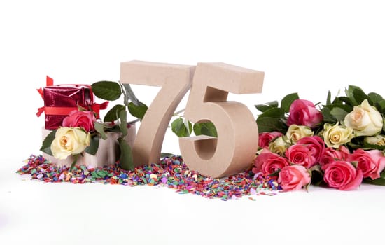 Number of age in a colorful studio setting with fresh roses on a bottom of confetti