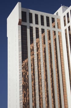 Casino building with blue skies and gold windows.